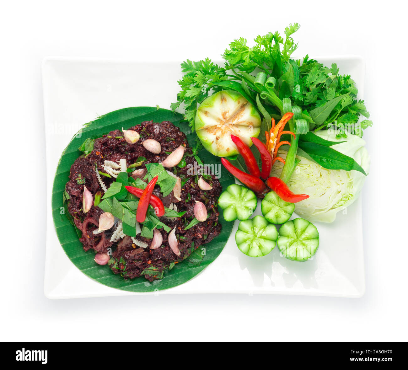 Spicy Raw Minced Beef Salad ingredient Spicy Herbs Thai Food Popular in Northern Style decorate with carved cucumber and vegetables top view Stock Photo