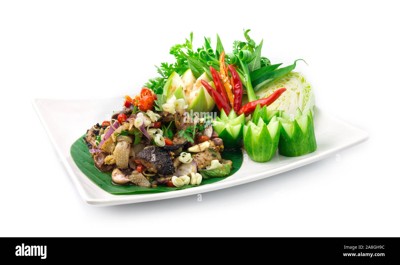 Spicy Raw Offal Beef Salad with ingredient Spicy Herbs Thai Food Popular in Northern Style decorate with carved cucumber and vegetables side view Stock Photo