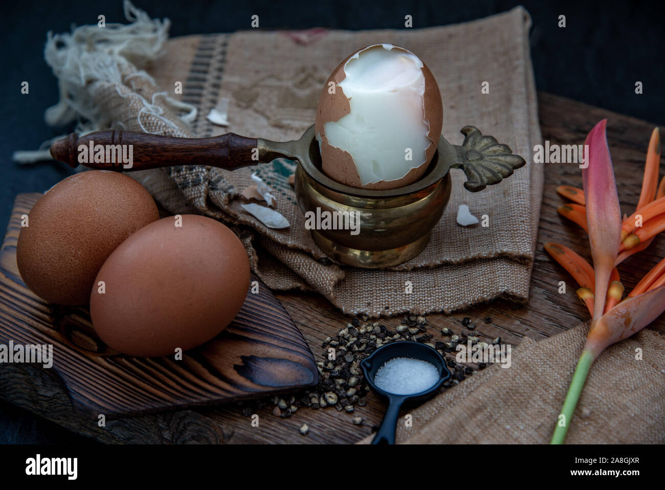 Boiled eggs with salt and pepper on beautiful wooden background ...