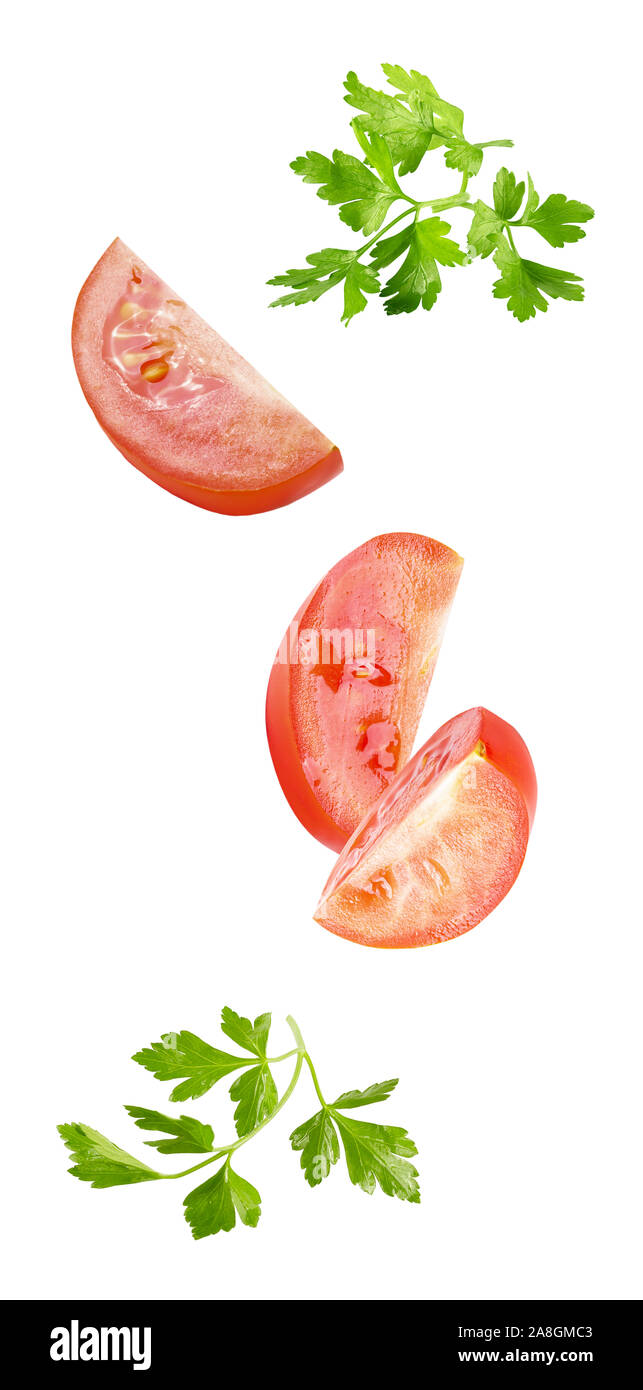 floating parsley and tomatoes isolated on white background Stock Photo