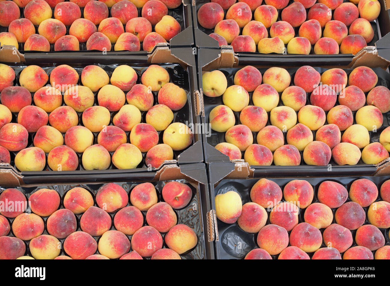 boxes of peaches for sale at grocery store in summer Stock Photo Alamy