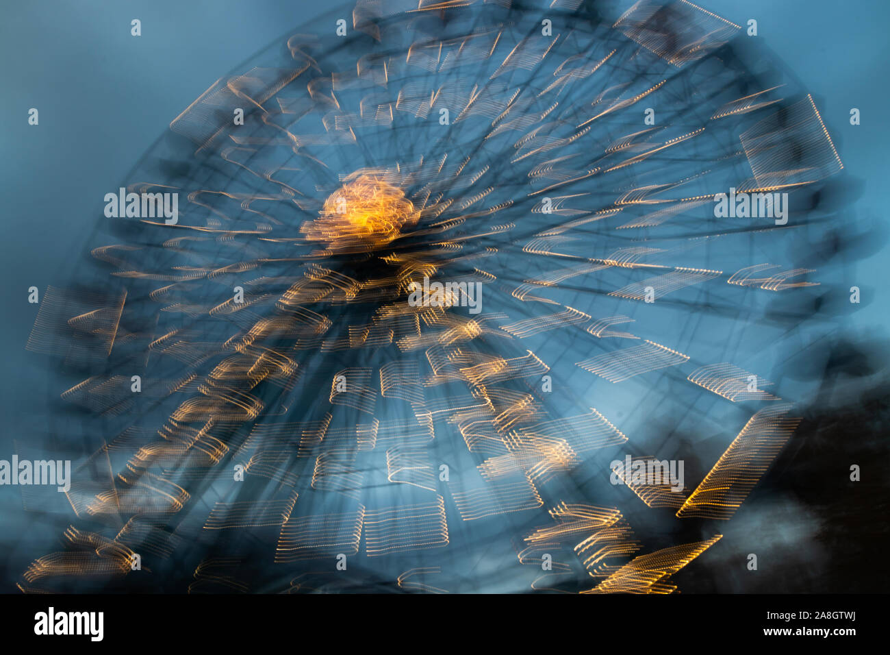 Blurred ferris wheel in motion at the amusement park, night ...