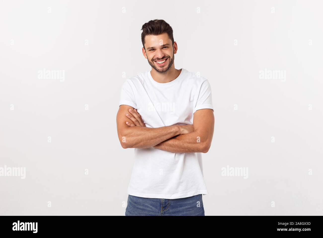 Portrait of a handsome young man smiling against white background Stock ...