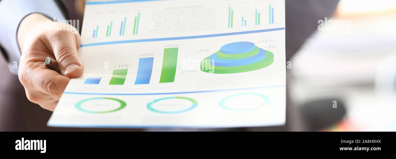 Person Analyzing Business Proceeds Using Graph Stock Photo