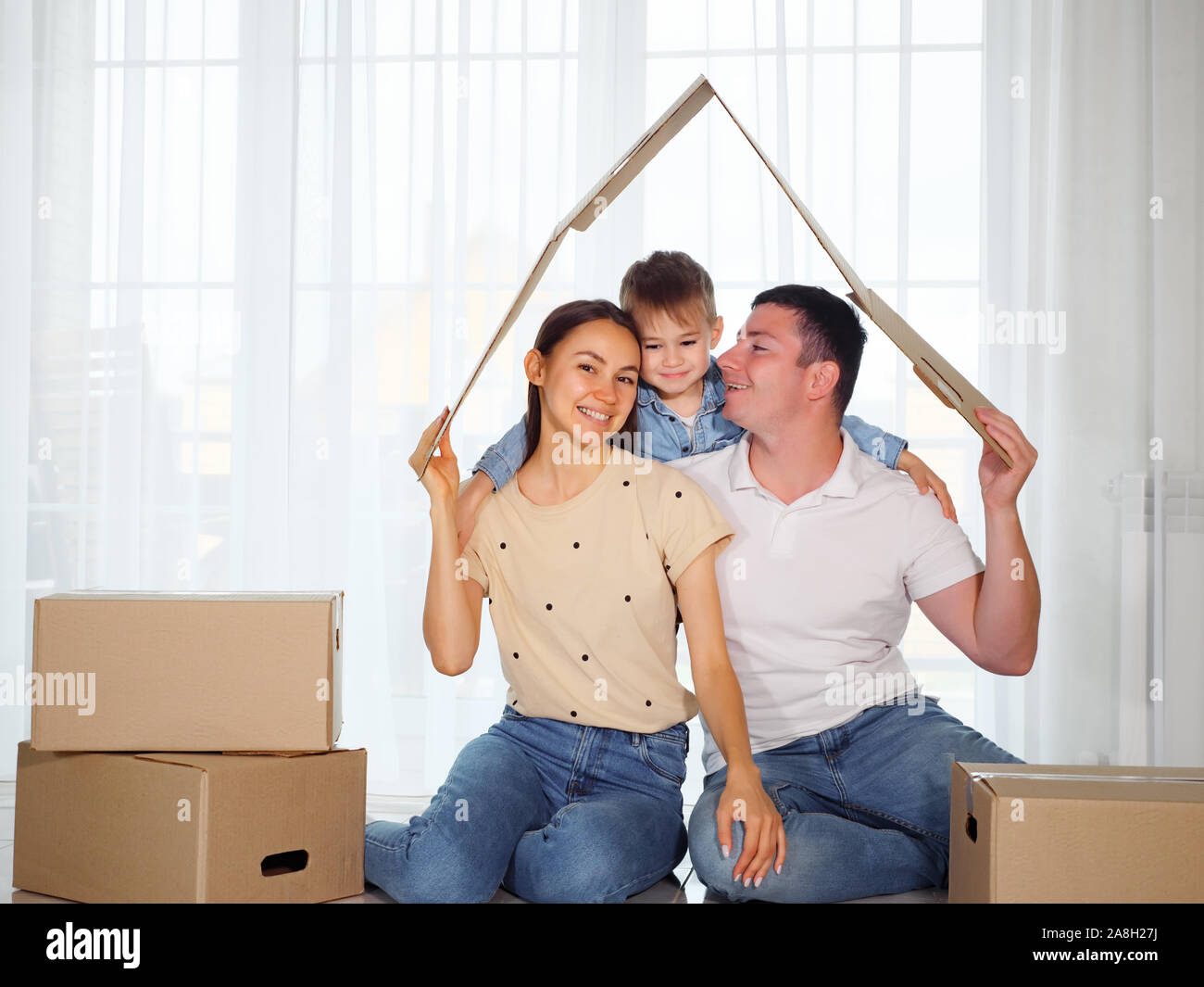concept housing a young family. Mother father and child in new house ...