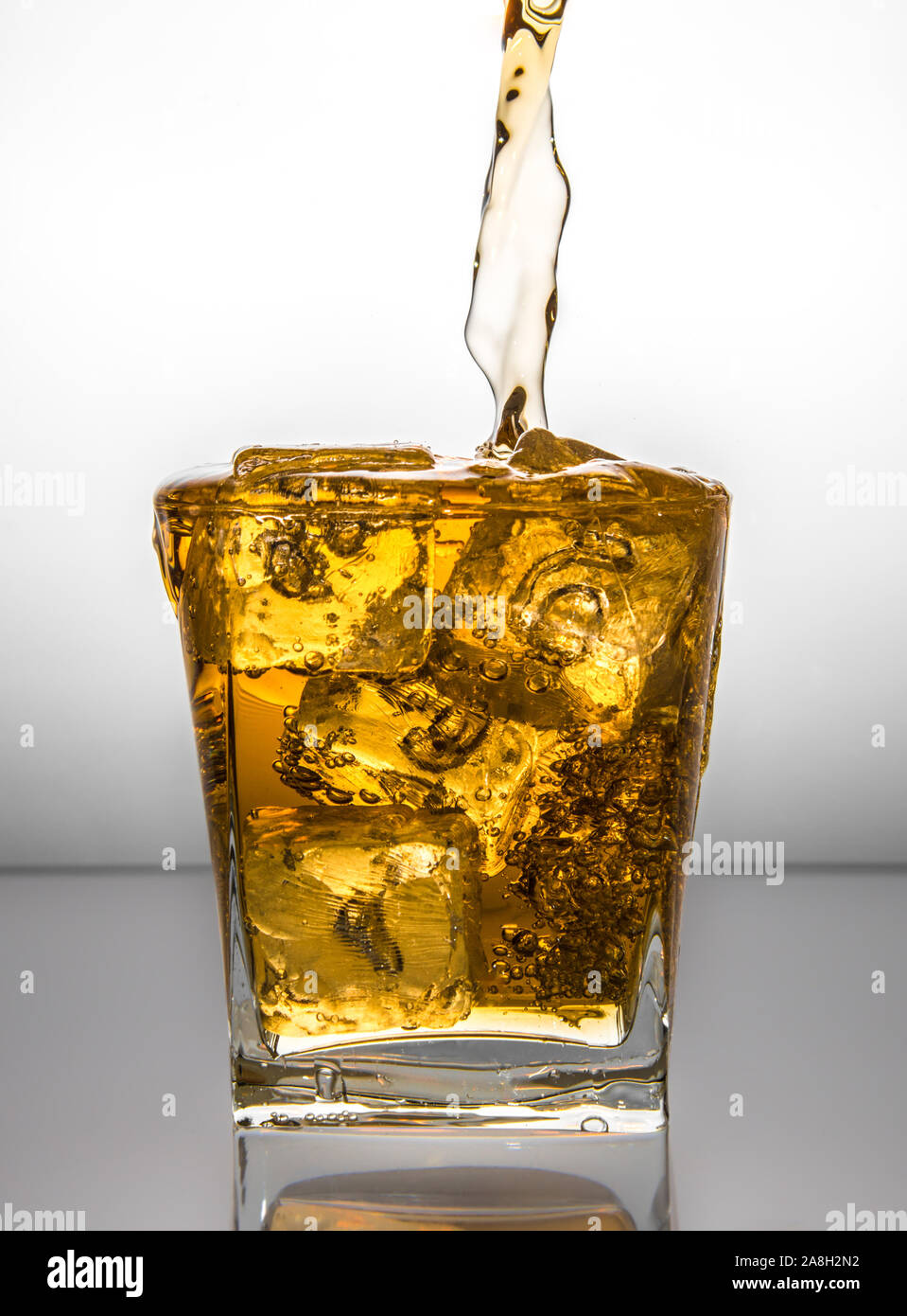 https://c8.alamy.com/comp/2A8H2N2/a-glass-with-ice-and-liquid-splash-2A8H2N2.jpg