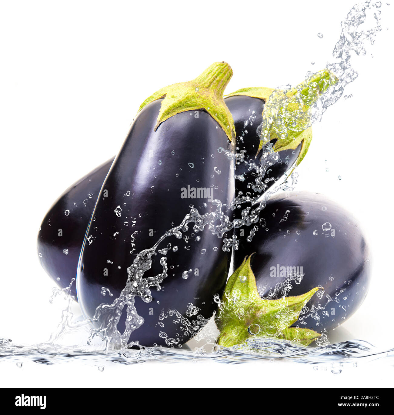 fresh aubergine falling in pure water Stock Photo