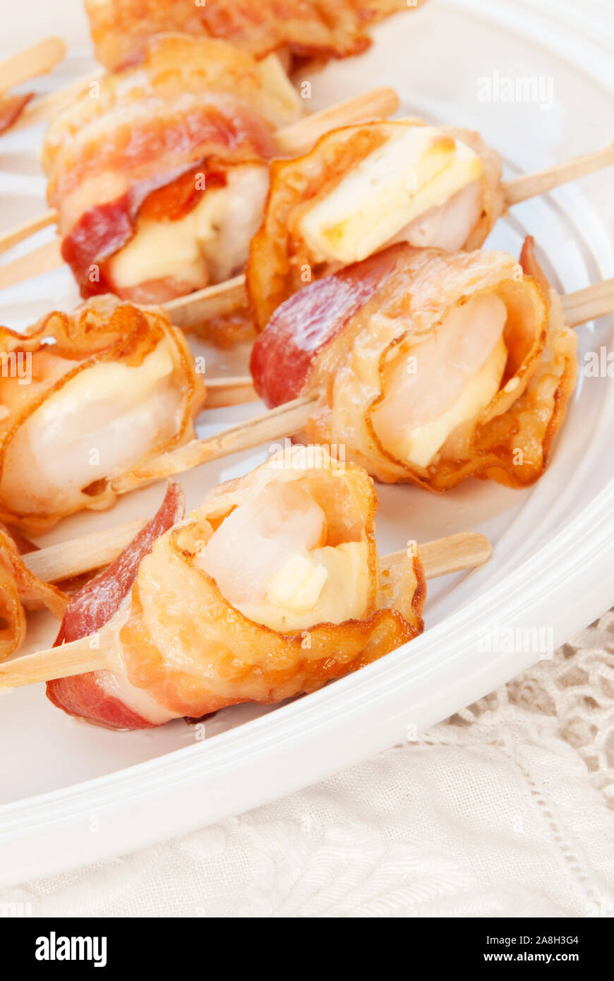 Shrimp appetizer made with pepper jack cheese wrapped in bacon. Wooden skewers makes for an easy
