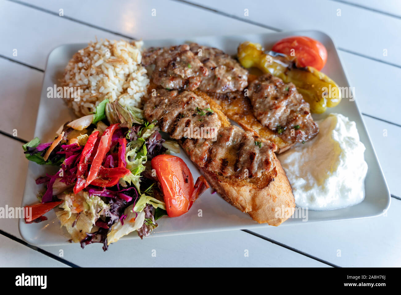 Grilled Meatballs , Rice Pilaf, Salad And Yoghurt On A Plate Stock