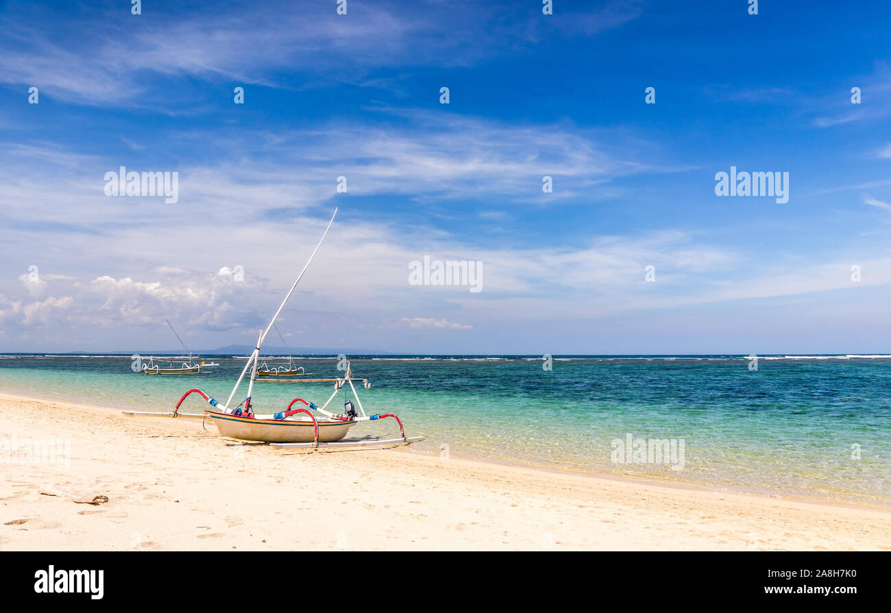 Traditional wooden boat on balinese shore in Indonesia Stock Photo