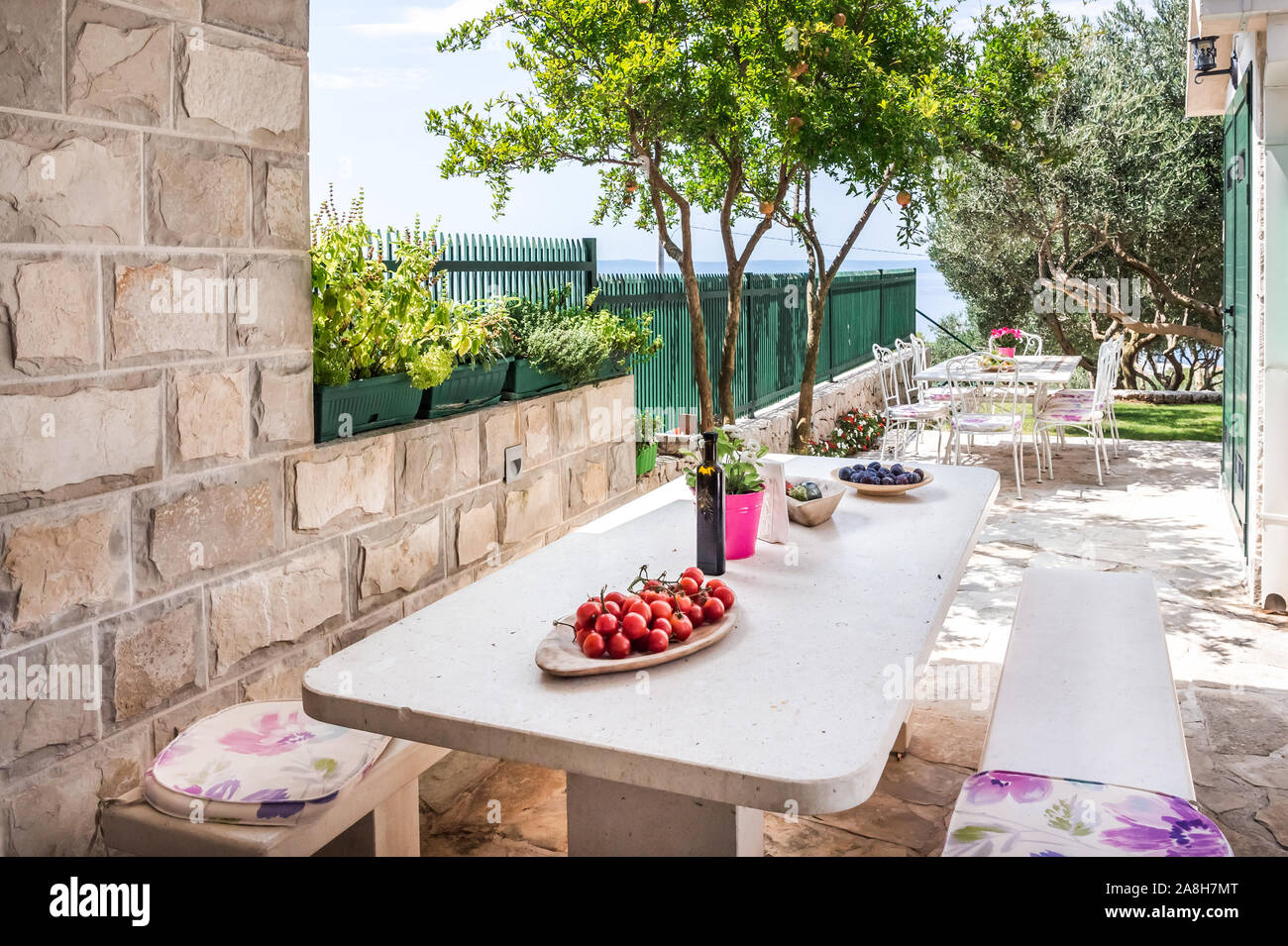 Table setting prepared for a meal with view on Mediterranean sea Stock Photo