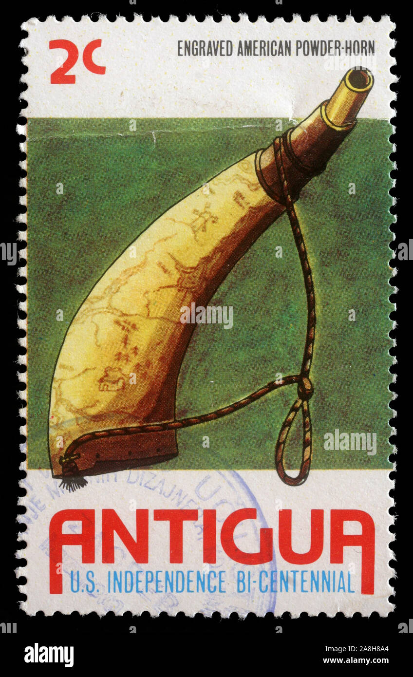 Stamp printed in Antigua shows Powder horn, Bicentenary of American Revolution series, circa 1976 Stock Photo
