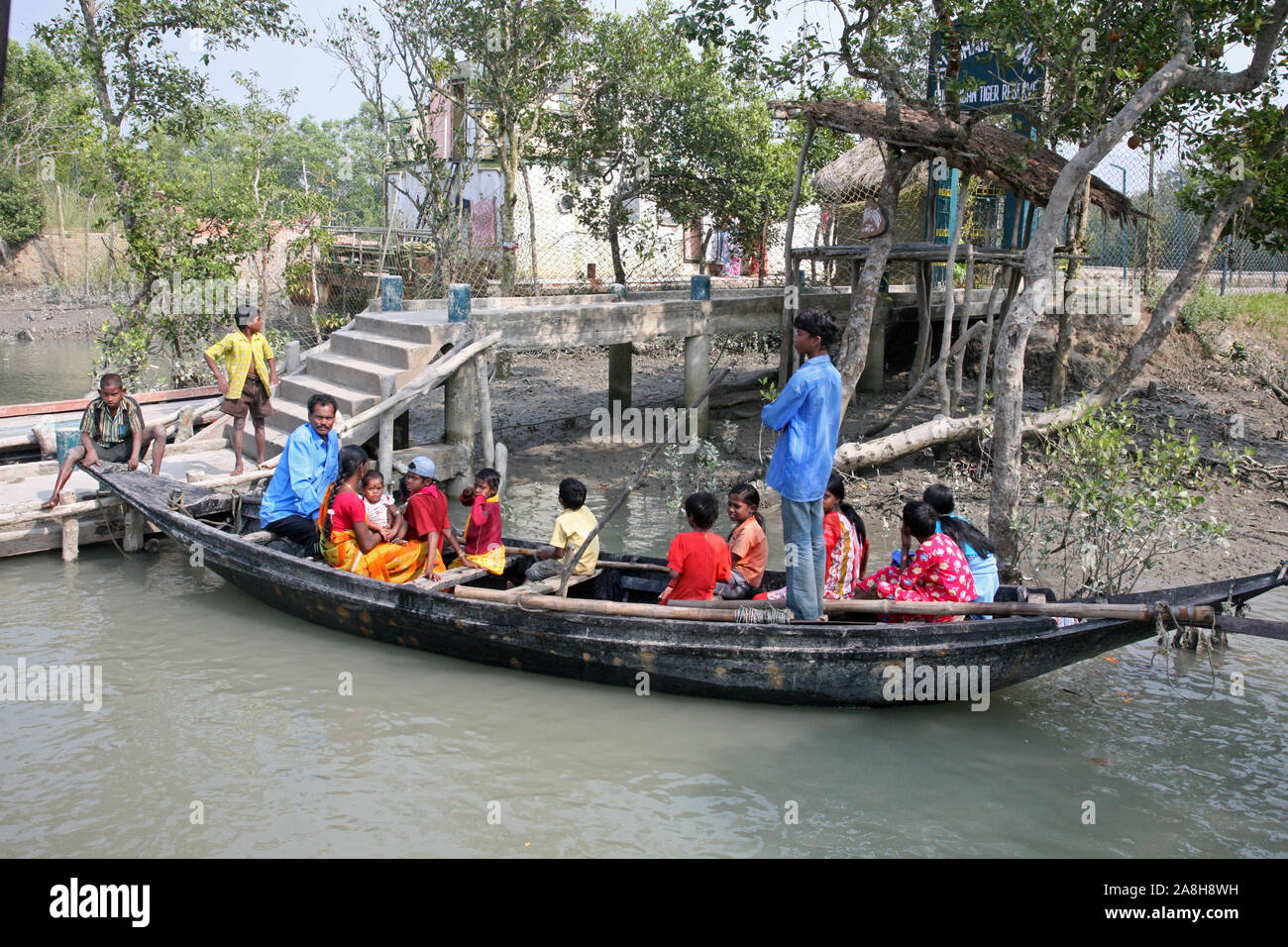 Wooden boat crosses the Ganges River in Gosaba, West Bengal, India ...