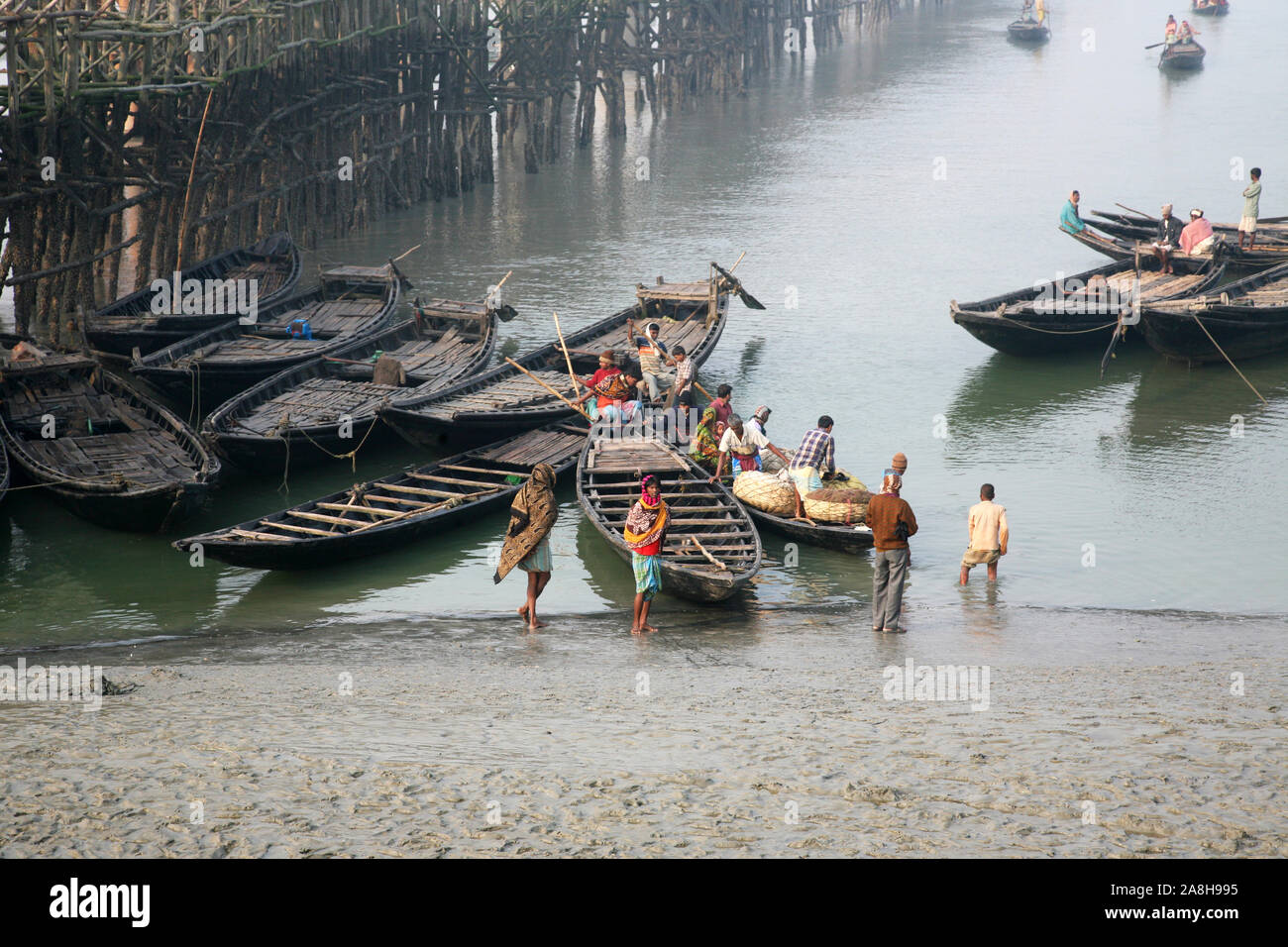 Wooden boat crosses the Matla River in Canning Town, West Bengal, India Stock Photo