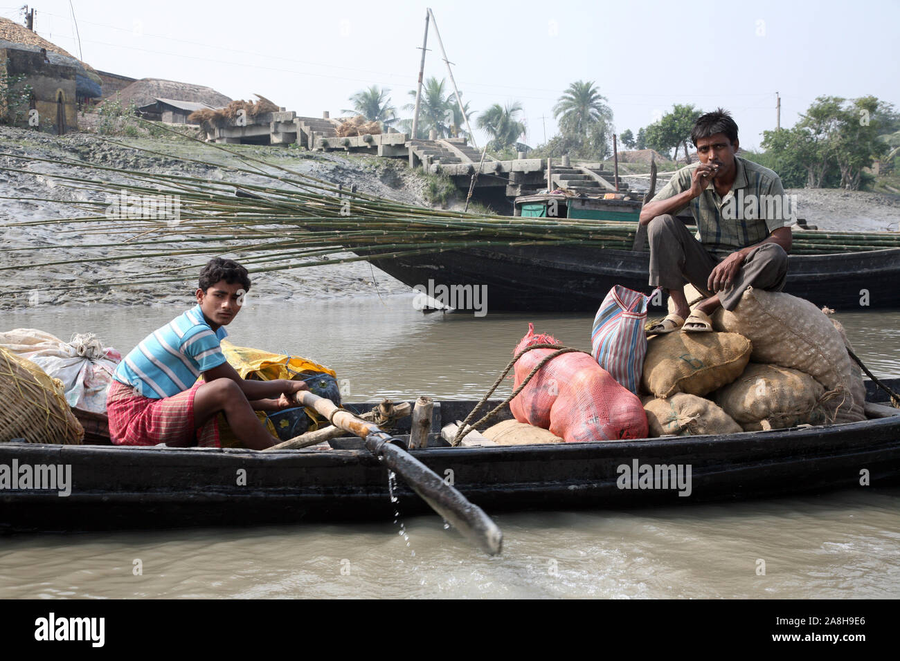 Wooden boat crosses the Ganges River in Gosaba, West Bengal, India ...
