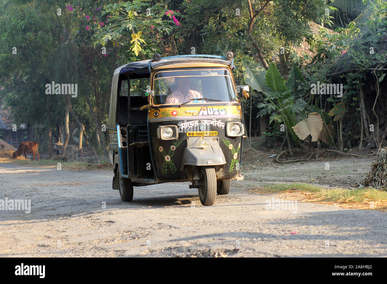 Auto rickshaw taxis on a road in Baidyapur, India Stock Photo