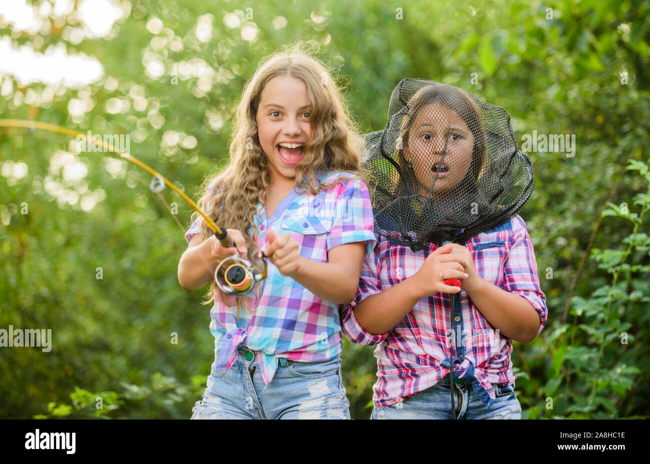 https://c8.alamy.com/comp/2A8HC1E/we-have-caught-it-kids-spend-time-in-camp-having-fun-fish-angler-two-girls-fishing-big-game-fishing-summer-hobby-happy-children-with-net-and-ro-2A8HC1E.jpg