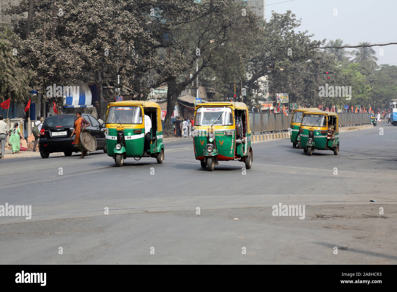 Auto rickshaw three weeler tuk-tuk taxi drives down the street in Kolkata Stock Photo