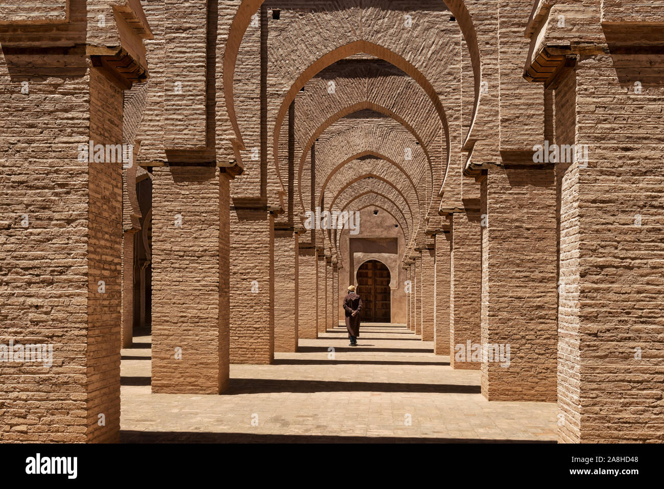 Traditional dressed man walks inside the Tinmal mosque, Morocco. Stock Photo