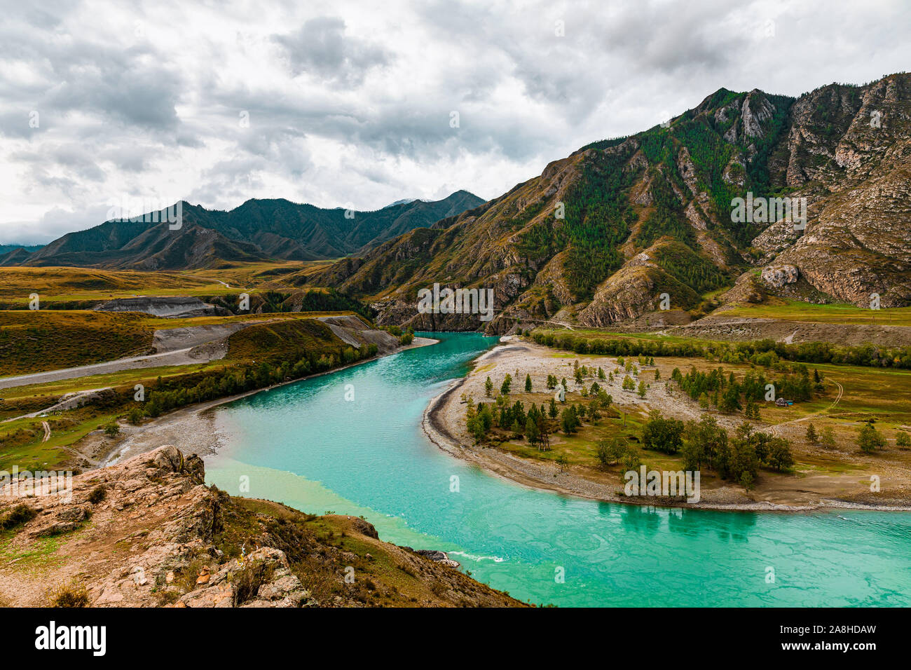 Panorama of mountain river on background of beautiful mountains in cloudy weather. View of turquoise river in the mountains on the background gloomy s Stock Photo