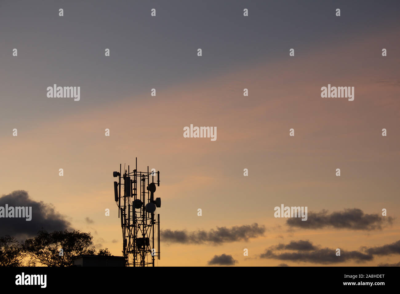 Mobile phone antennas on a building roof with sky background. Antennas