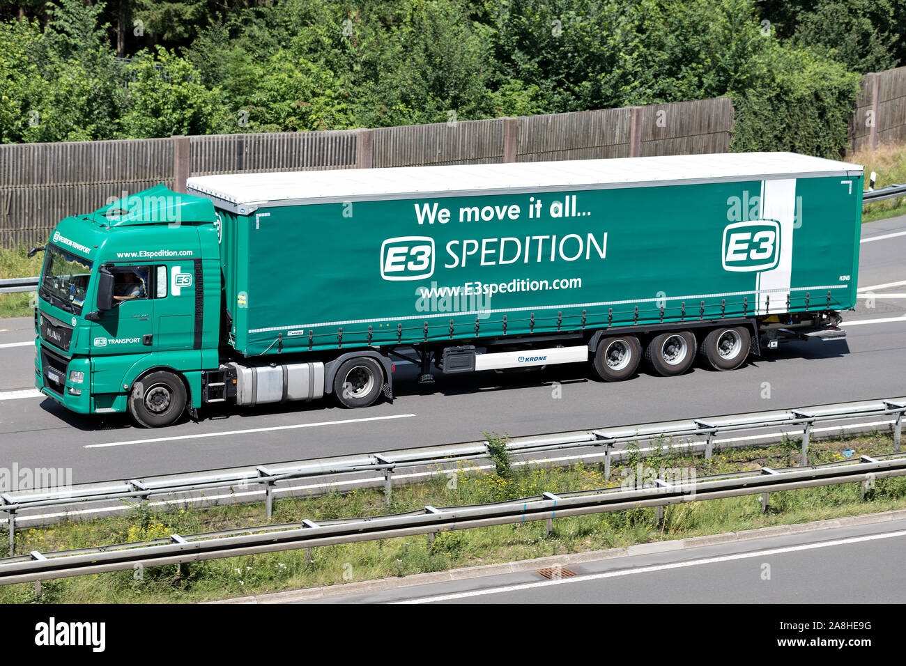 E3 Spedition MAN TGX truck with curtainside trailer on motorway. Stock Photo