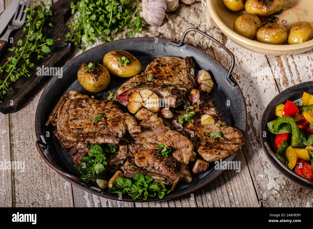 Delicious grilled meat seasoned with garlic and pepper, fresh salad