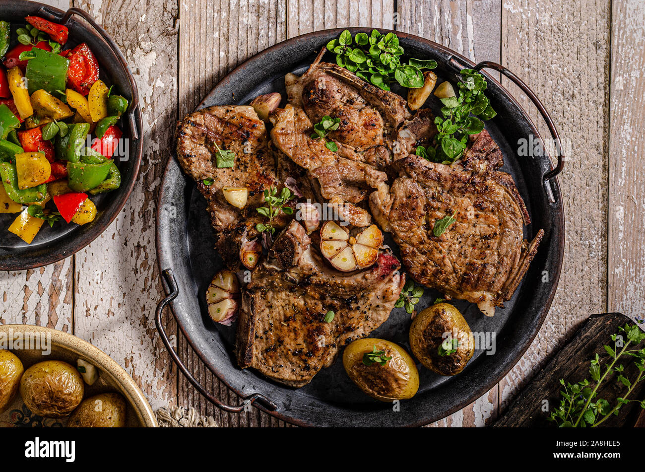 Delicious grilled meat seasoned with garlic and pepper, fresh salad