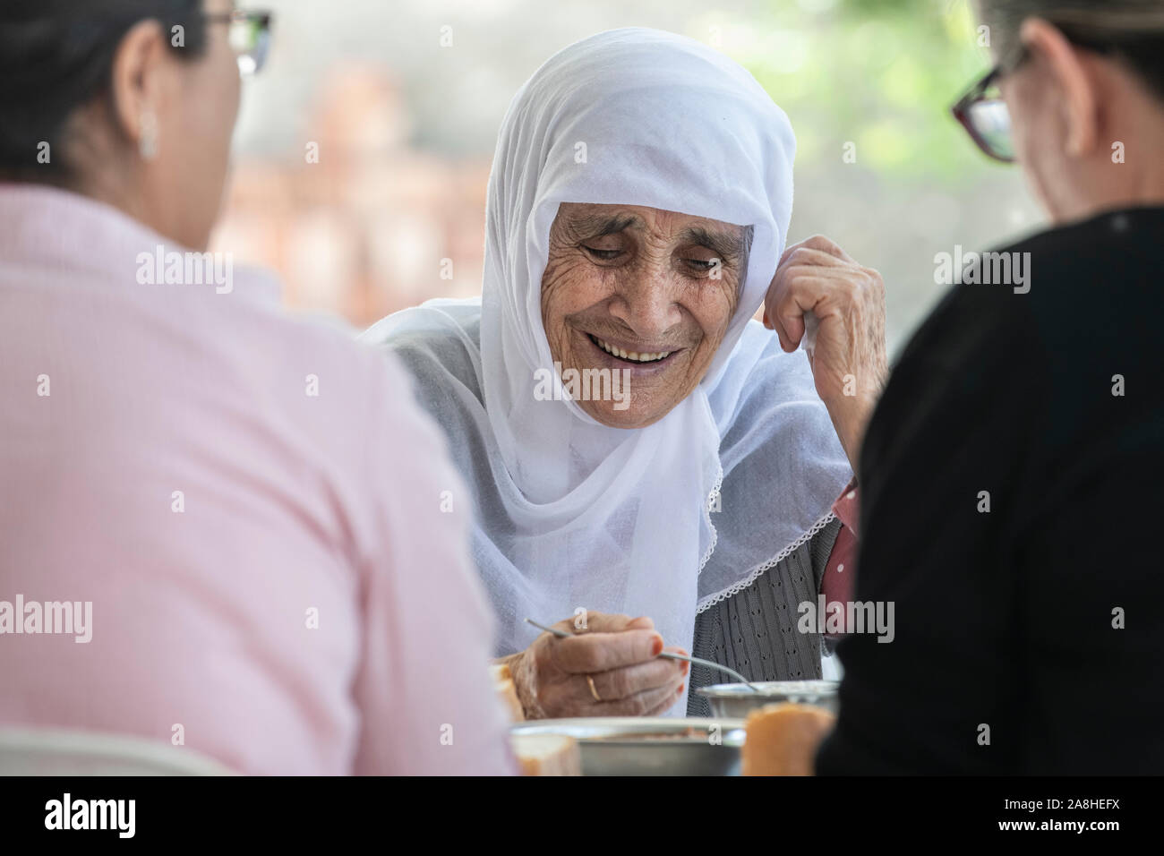 A beautiful, elderly lady wearing a white hajib, living a semi nomadic lifestyle in a village in Turkey Stock Photo