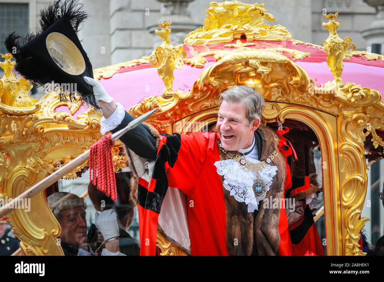 City of London, London, UK, 09th November 2019.  The 692nd Lord Mayor of London, Alderman William Russell, waves from the golden State Coach at St Paul's as the crowds cheer on the parade. The annual Lord Mayor's Show, a parade through the City of London that is 804 years old and this year features over 6000 participants, sees marching bands, military detachments, carriages, dance troupes, inflatables and many others make their way from Mansion House, via St Paul's to the Royal Courts of Justice. Credit: Imageplotter/Alamy Live News Credit: Imageplotter/Alamy Live News Stock Photo