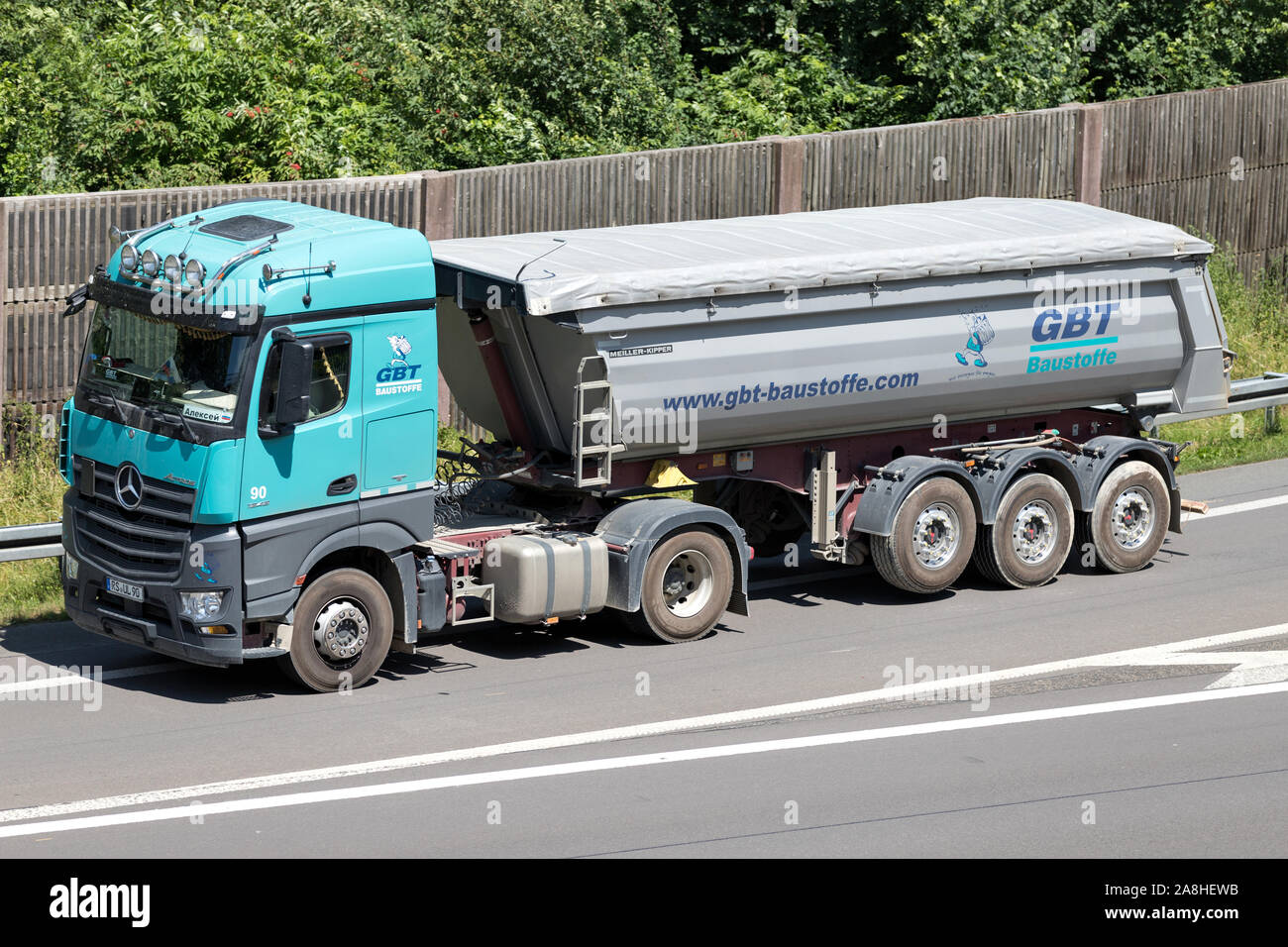 GBT Baustoffe Mercedes-Benz Actros truck with tipper trailer on motorway. Stock Photo