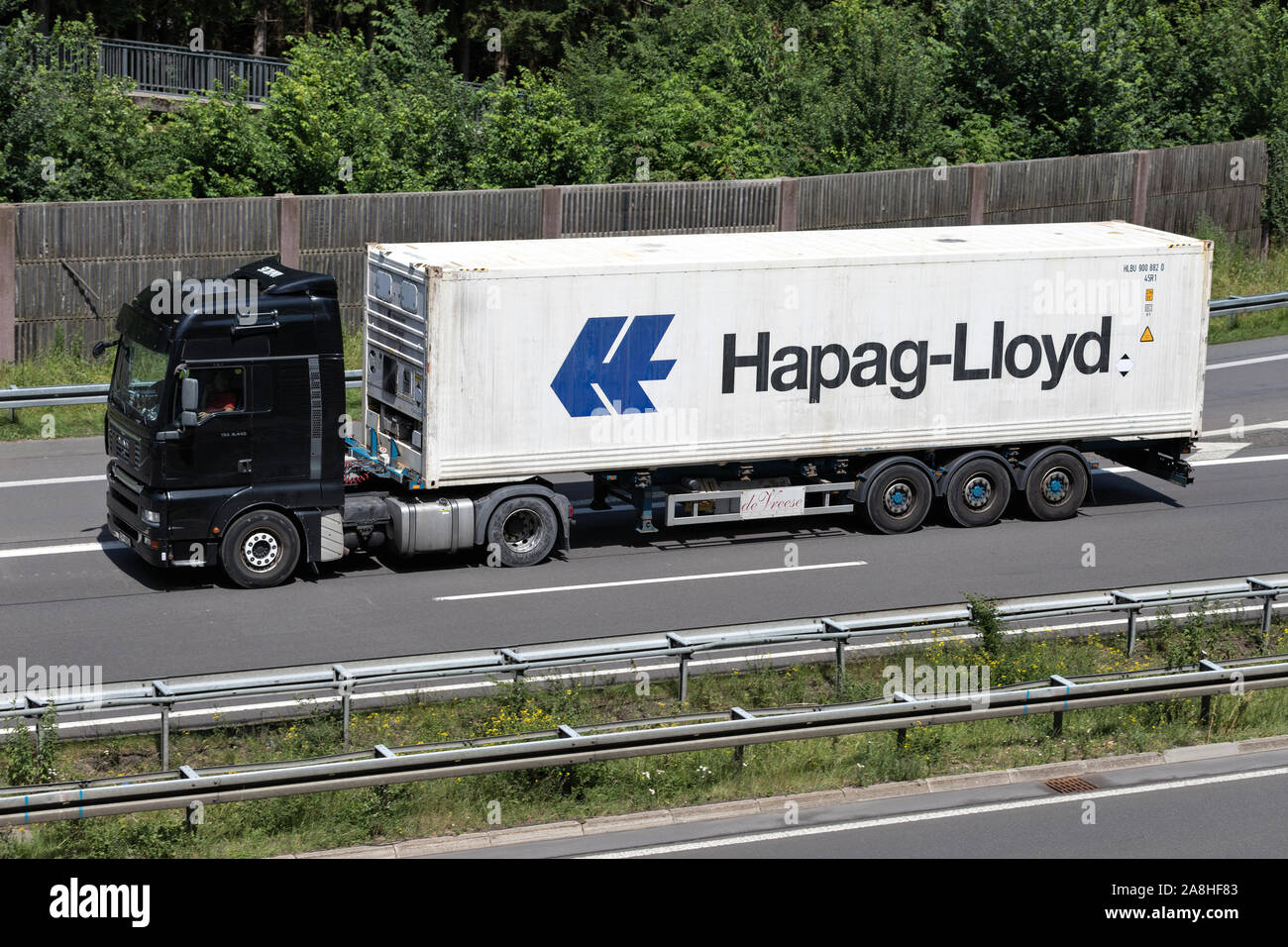 MAN TGA truck with Hapag-Lloyd container on motorway. Stock Photo