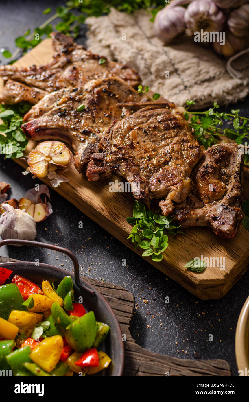 Delicious grilled meat seasoned with garlic and pepper, fresh salad