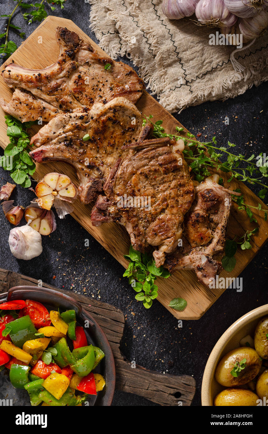 Delicious grilled meat seasoned with garlic and pepper, fresh salad