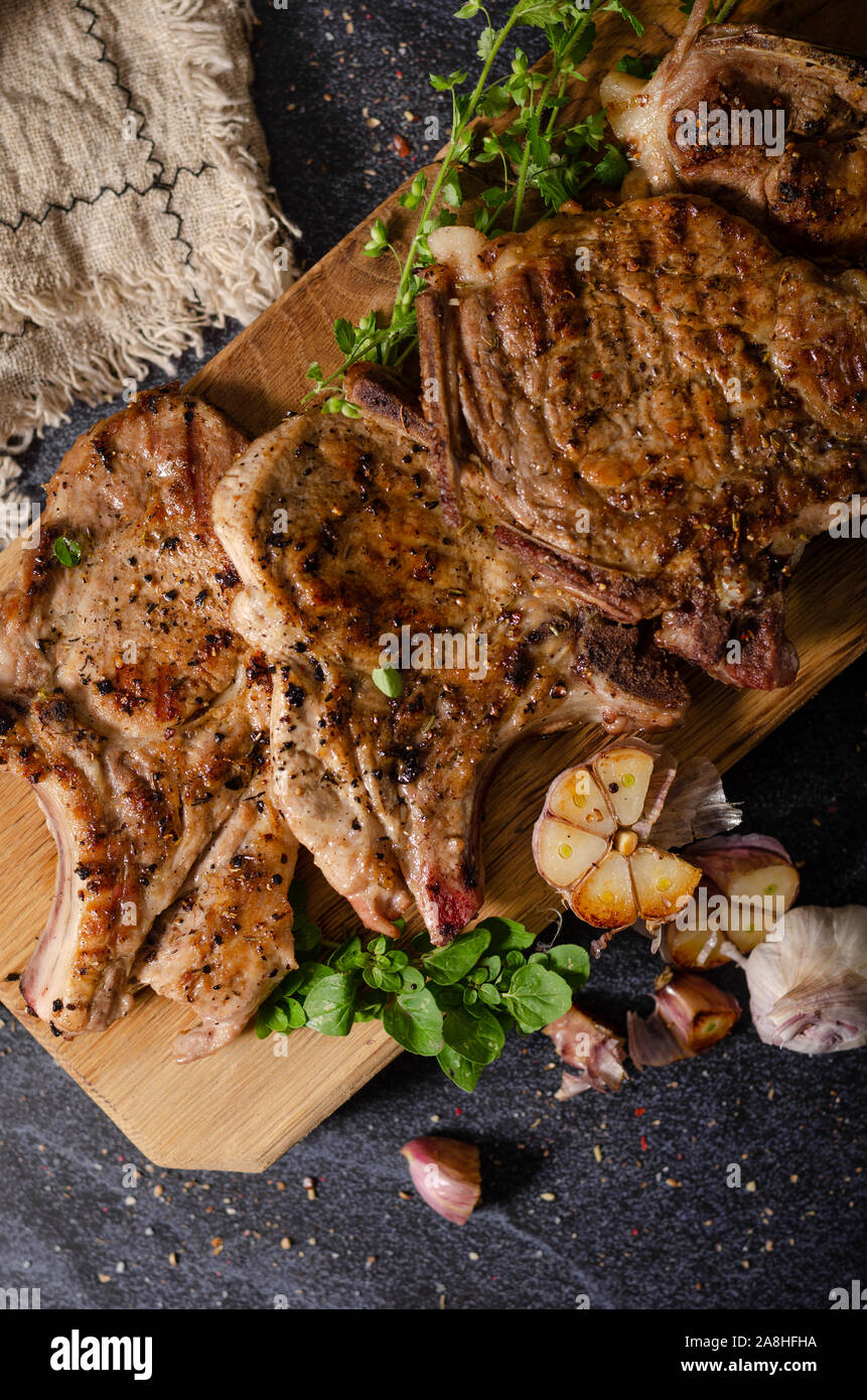 Delicious grilled meat seasoned with garlic and pepper, fresh salad
