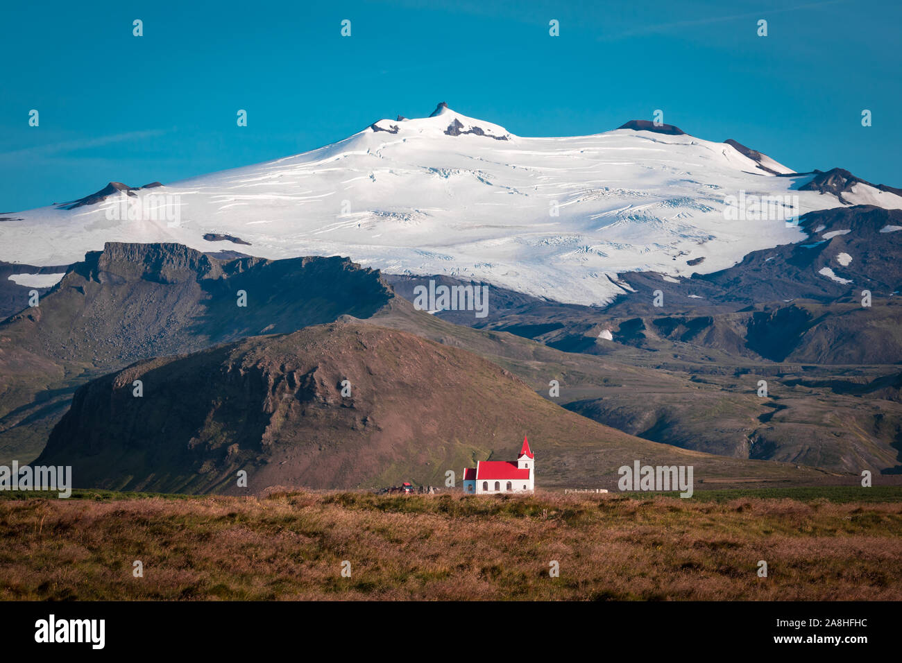 What an eyecatcher, this tiny little church under the huge Snaefell Glacier... Stock Photo