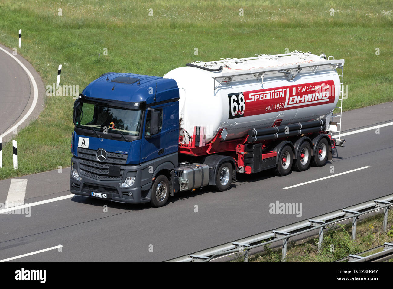Löhwing Mercedes-Benz Actros truck with silo trailer on motorway. Stock Photo
