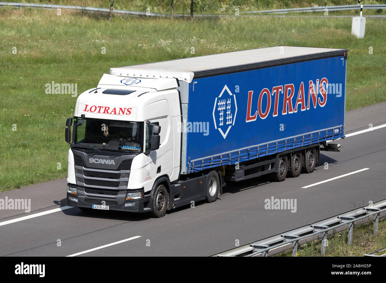 Lotrans Scania truck with curtainside trailer on motorway. Stock Photo