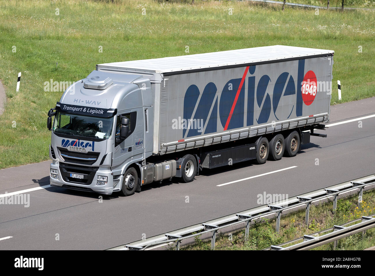 Maisel Iveco Stralis truck with curtainside trailer on motorway. Stock Photo