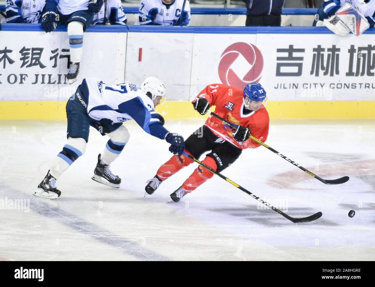 (191109) -- JILIN CITY, Nov. 9, 2019 (Xinhua) -- Buran's Yegor Alyoshin (L) competes during a 21st round match between Tsen Tou of China and Buran of Russia at the Silk Road Supreme Ice Hockey League in Jilin City, northeast China's Jilin Province, on Nov. 9, 2019. (Photo by Yan Linyun/Xinhua) Stock Photo