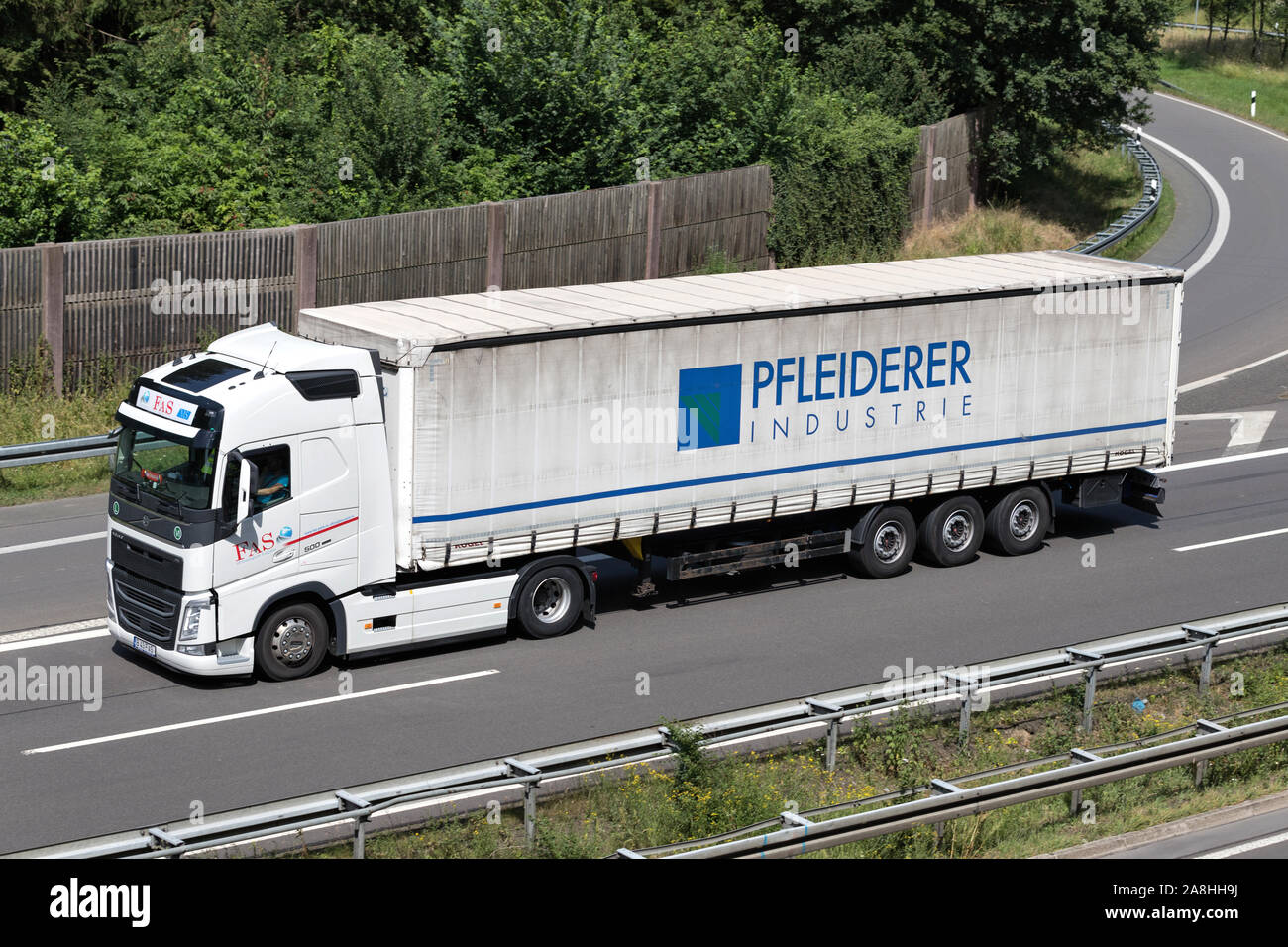 FAS Volvo FH truck with Pfleiderer curtainside trailer on motorway. Stock Photo