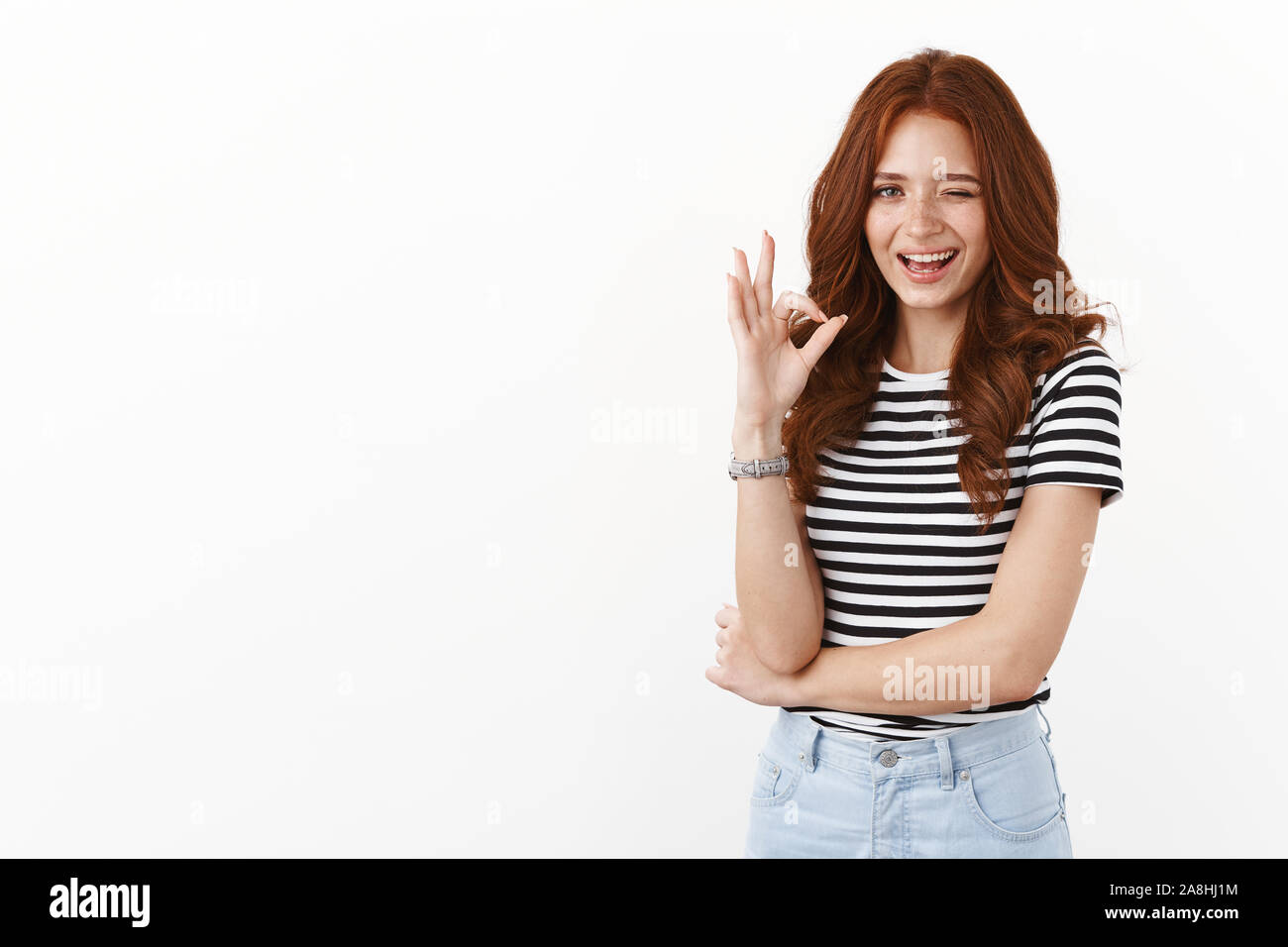 Cheeky playful redhead female in striped t-shirt wink suggestive, showing  okay approval sign, smiling have hidden meaning, flirty agree, liking Stock  Photo - Alamy
