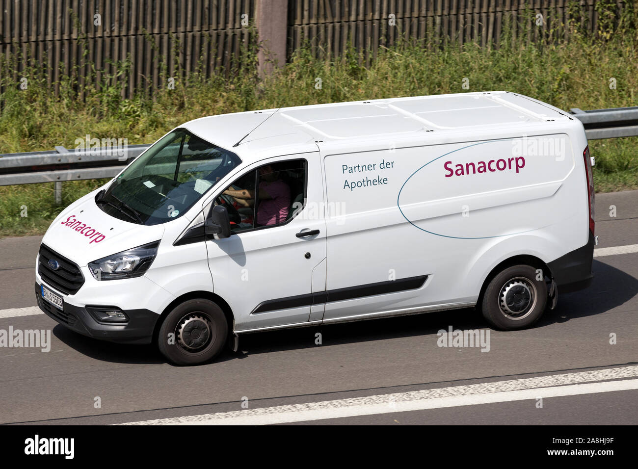 Sanacorp van on motorway. The Sanacorp pharmacist cooperative is one of the leading pharmaceutical wholesalers in Germany. Stock Photo