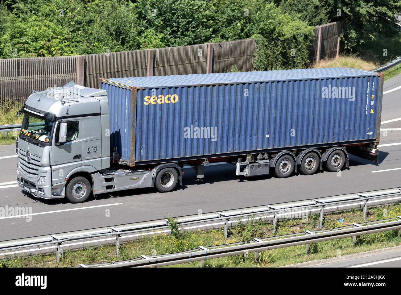 Mercedes-Benz Actros truck with seaco container on motorway. Stock Photo