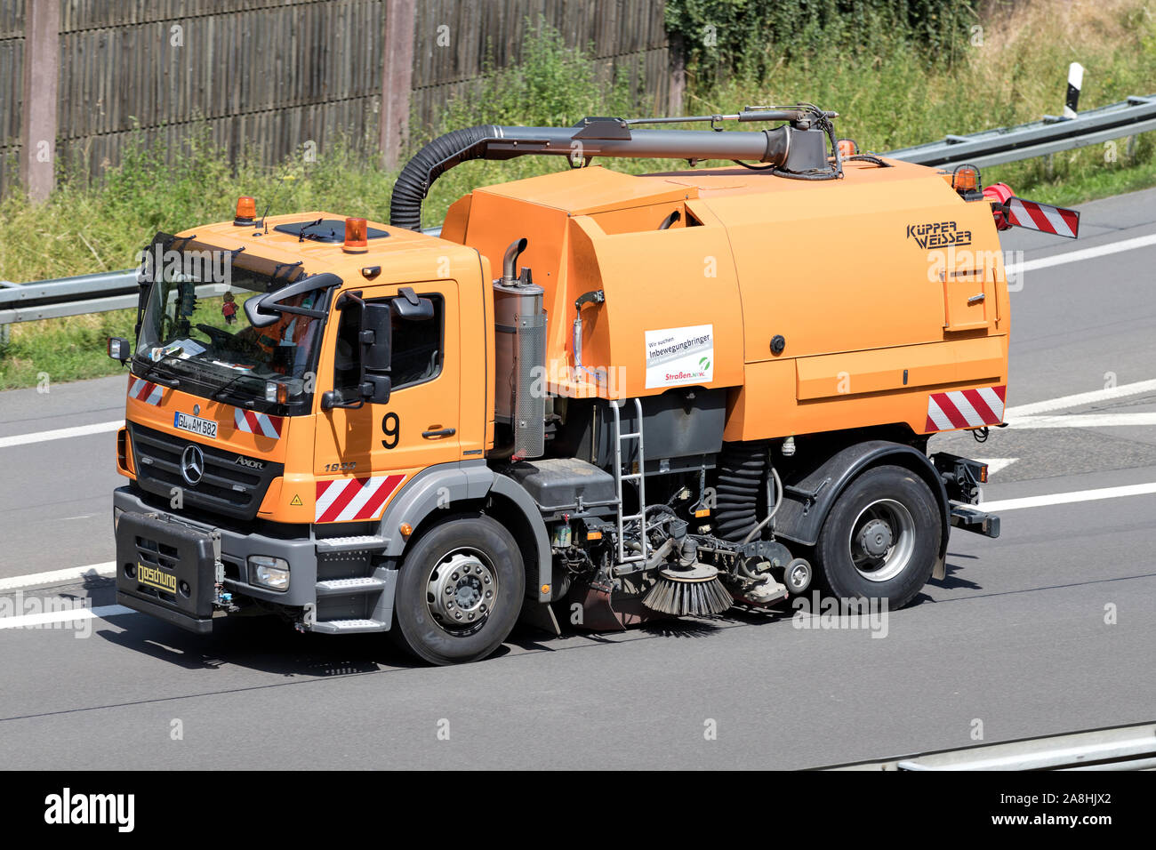 Strassen NRW Mercedes-Benz Axor road sweeper on motorway. Stock Photo