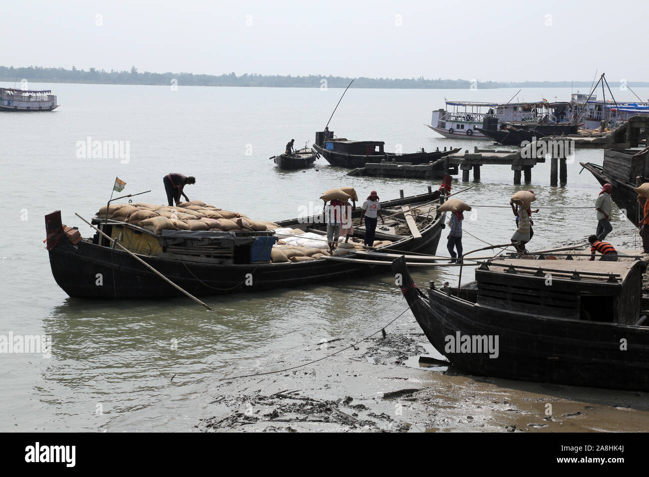 Wooden boat crosses the Ganges River in Gosaba, West Bengal, India ...