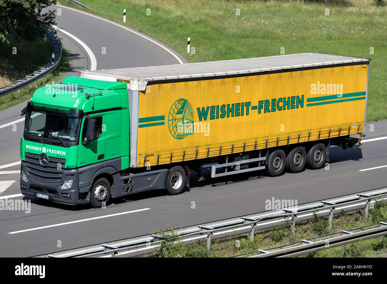 Weisheit Mercedes-Benz Actros truck with curtainside trailer on motorway. Stock Photo