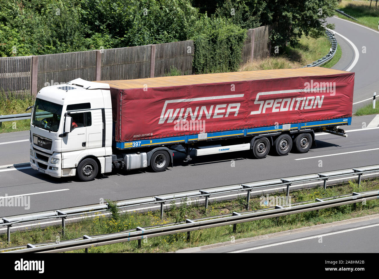 MAN TGX truck with Winner tarpaulin trailer on motorway Stock Photo - Alamy