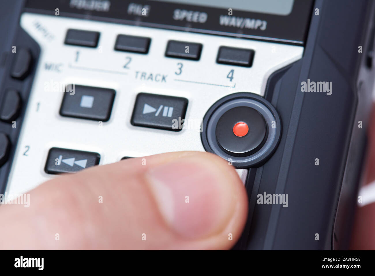 Macro of hand holding audio recorder close up view Stock Photo