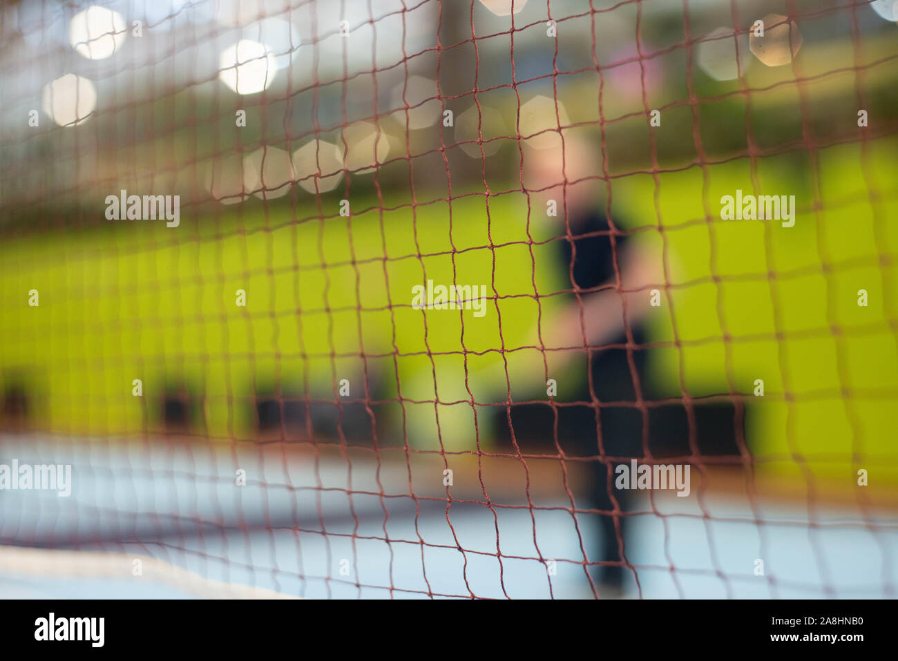 Badminton Net in focus with player Stock Photo